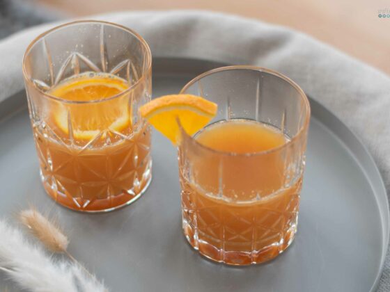 hot orange punch for cold days in stylish whiskey mugs