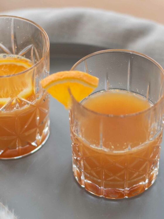 hot orange punch for cold days in stylish whiskey mugs